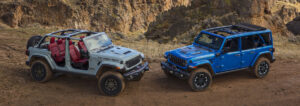 Two Jeep® Wrangler SUVs on a desert road.