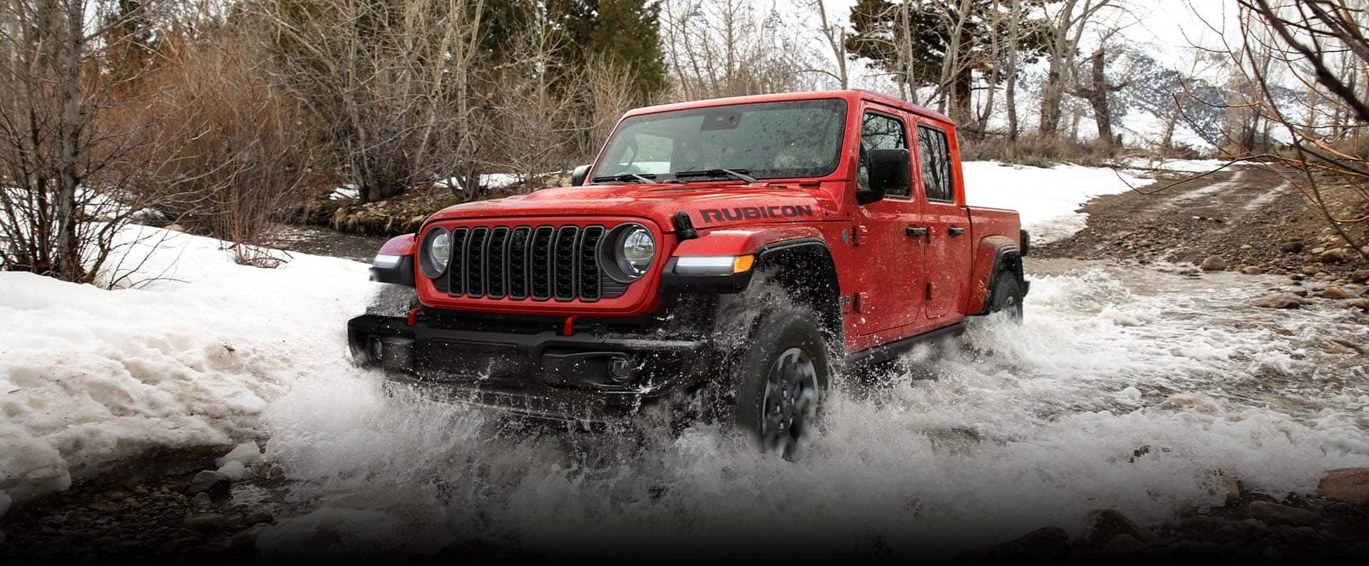 A Jeep Gladiator driving through water.